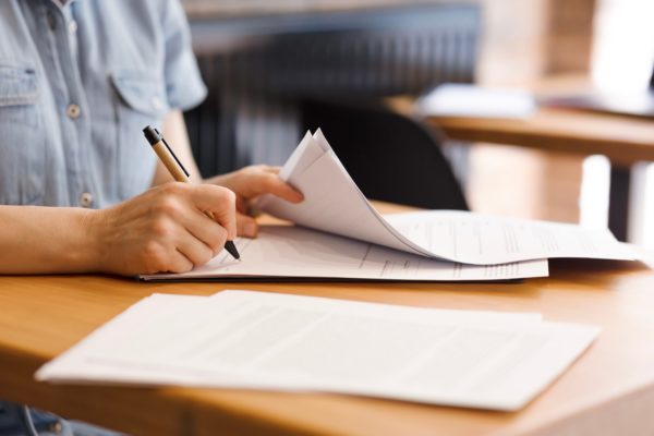Female,Hands,With,Pen,Signing,Documents,,Business,Papers,On,Wooden Female,Hands,With,Pen,Signing,Documents,,Business,Papers,On,Wooden